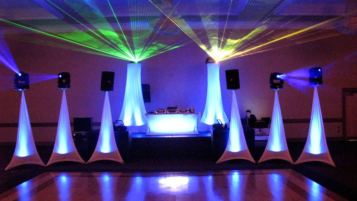 Toronto ballroom prepared for a wedding reception with sculptural white draping and atmospheric lighting