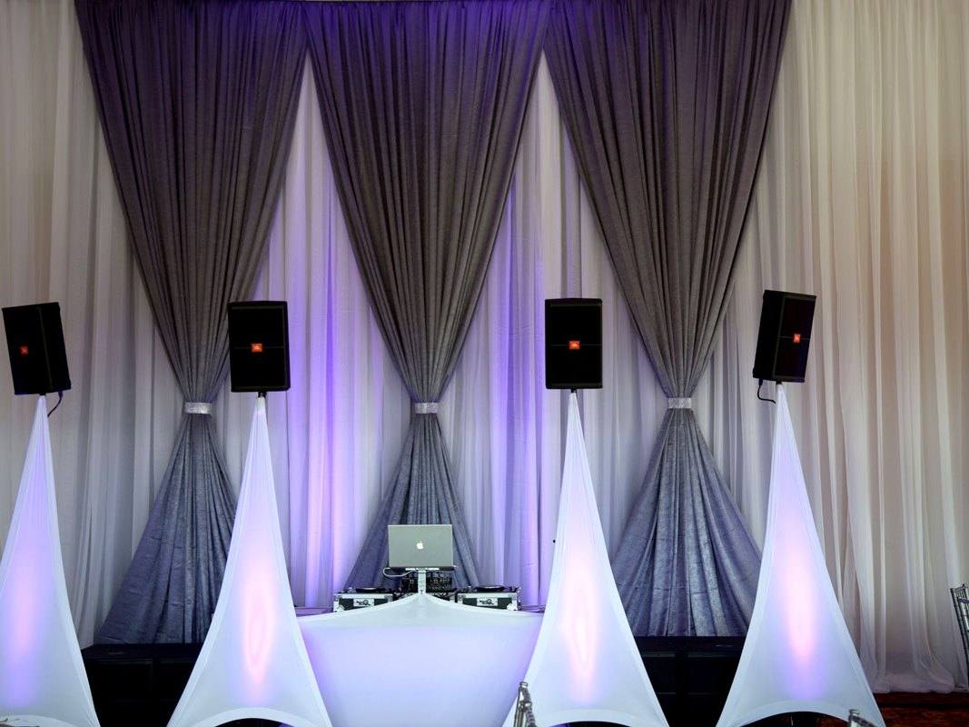Pipe and drape backdrop installed behind a stage at a Toronto event venue