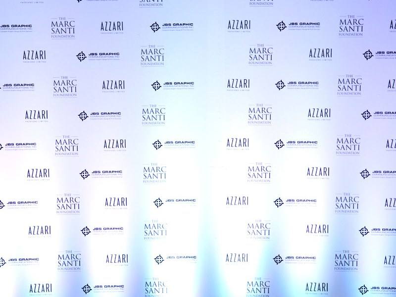 Step-and-repeat backdrop lit evenly from both sides before guests arrive